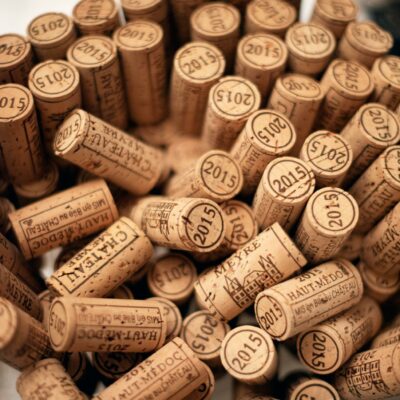 From above of pile of similar bottle cork stoppers of alcohol drinks stacked on table